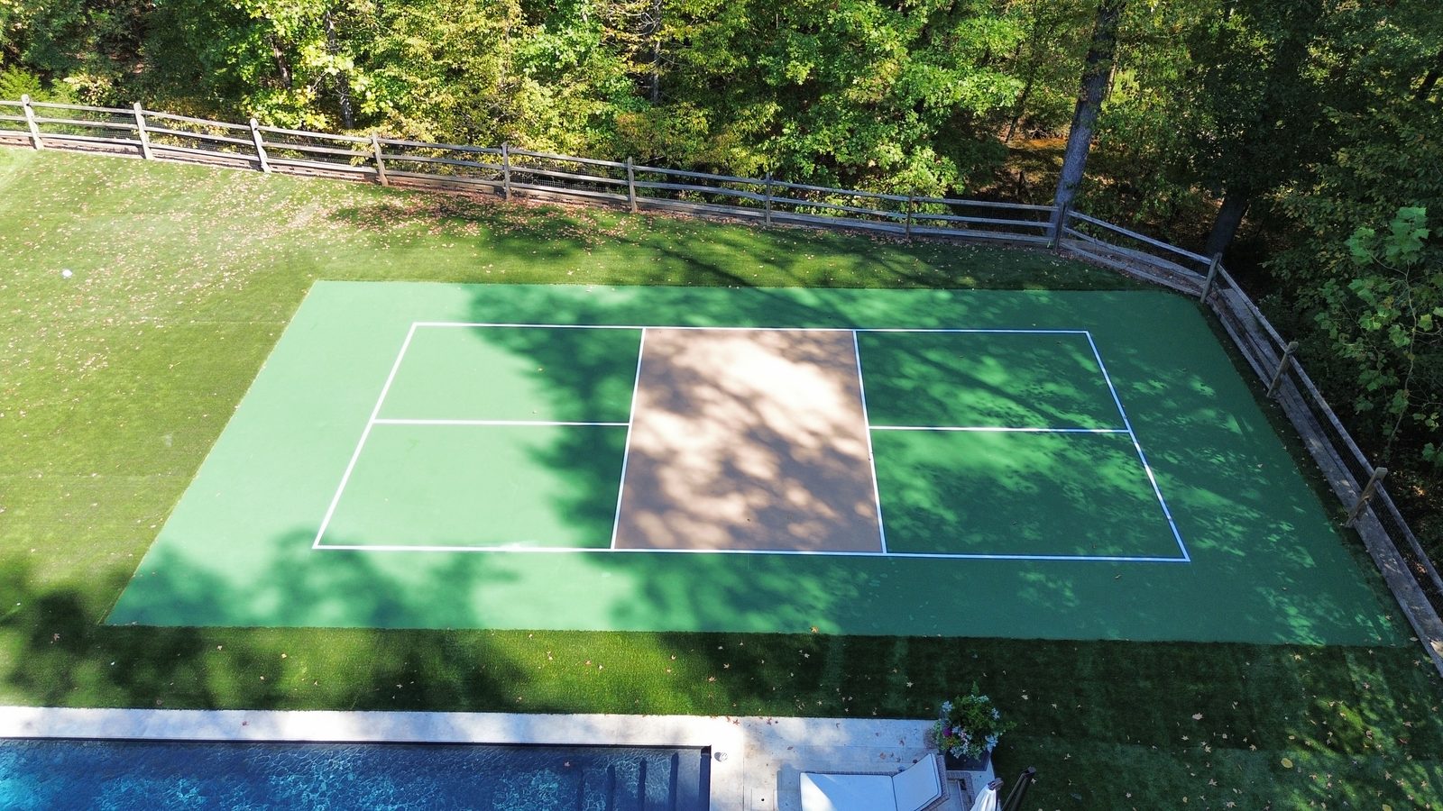 Aerial backyard pickleball court beside pool NC